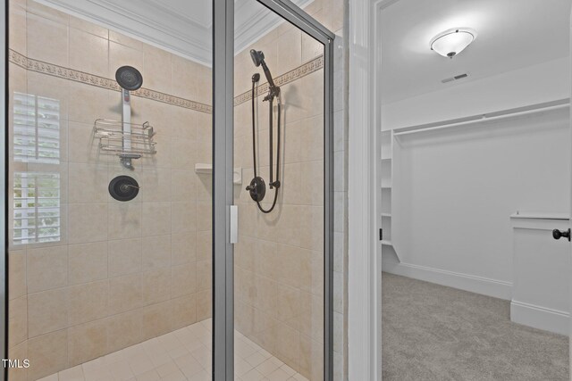 3323 Cheswick Dr, Raleigh, NC 27609 - bathroom featuring a shower stall, crown molding, and a walk in closet