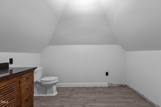 3323 Cheswick Dr, Raleigh, NC 27609 - bathroom featuring lofted ceiling, wood finished floors, and toilet