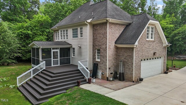 3323 Cheswick Dr, Raleigh, NC 27609 - rear view of house with a sunroom, concrete driveway, a shingled roof, a garage, and a yard