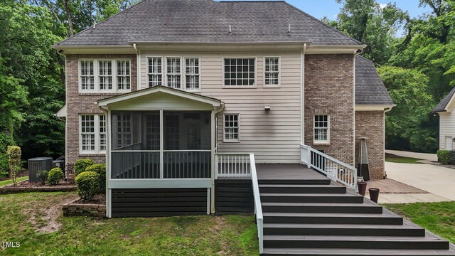 3323 Cheswick Dr, Raleigh, NC 27609 - rear view of property with a sunroom, central air condition unit, brick siding, and roof with shingles