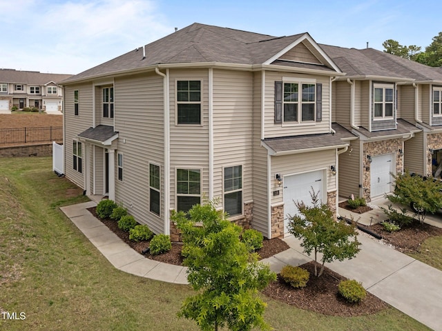 view of front of house with a garage, driveway, stone siding, and roof with shingles