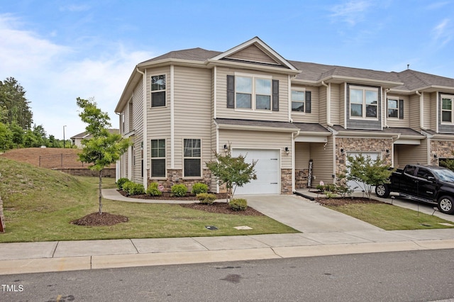 view of front of house with an attached garage, stone siding, and concrete driveway
