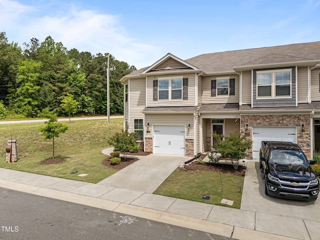 view of front of home with driveway, a front lawn, an attached garage, stone siding, and a shingled roof