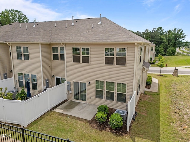 back of property featuring a patio area, central air condition unit, and roof with shingles