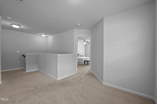 unfurnished room featuring carpet floors, baseboards, and ceiling fan