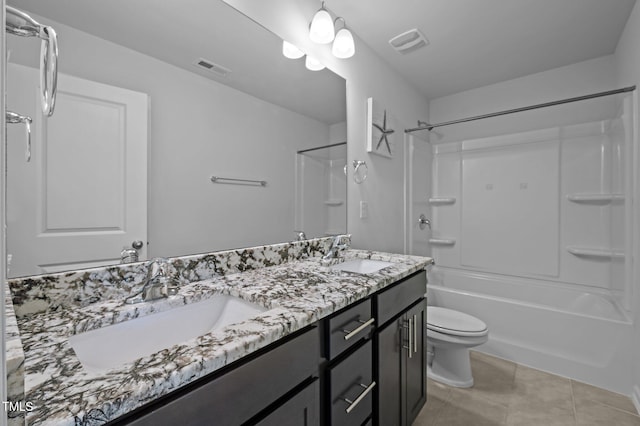 bathroom featuring toilet, tile patterned flooring, double vanity, and washtub / shower combination
