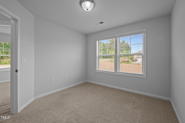 carpeted spare room with baseboards