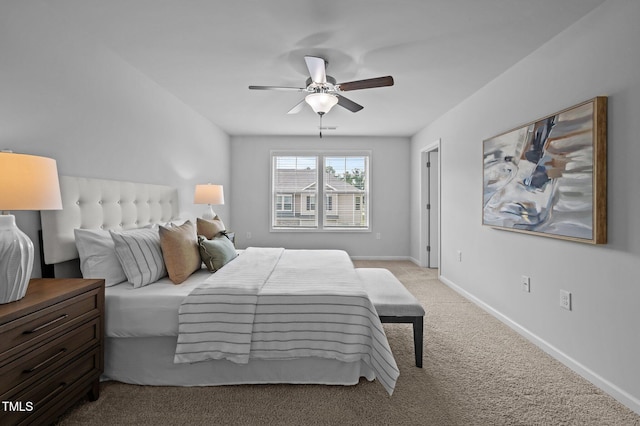 carpeted bedroom featuring baseboards and a ceiling fan