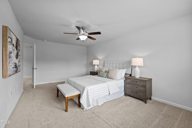 carpeted bedroom with baseboards and a ceiling fan