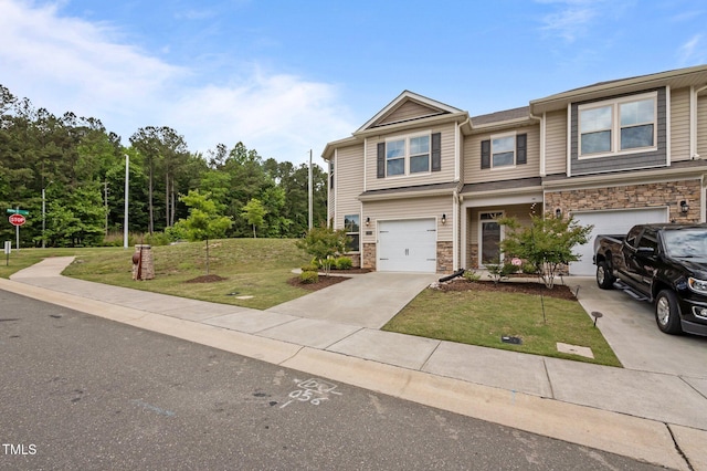 view of front facade featuring stone siding, a front yard, driveway, and a garage