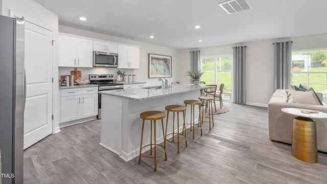 209 Wood St, La Grange, NC 28551 - kitchen featuring appliances with stainless steel finishes, a sink, light wood-type flooring, plenty of natural light, and recessed lighting
