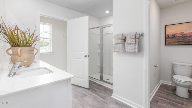 209 Wood St, La Grange, NC 28551 - full bathroom with wood finished floors, a shower stall, toilet, and recessed lighting