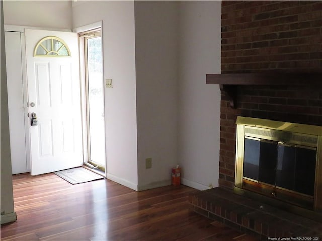 5609 Bowman Ct, Fayetteville, NC 28304 - foyer with wood finished floors, a brick fireplace, and baseboards