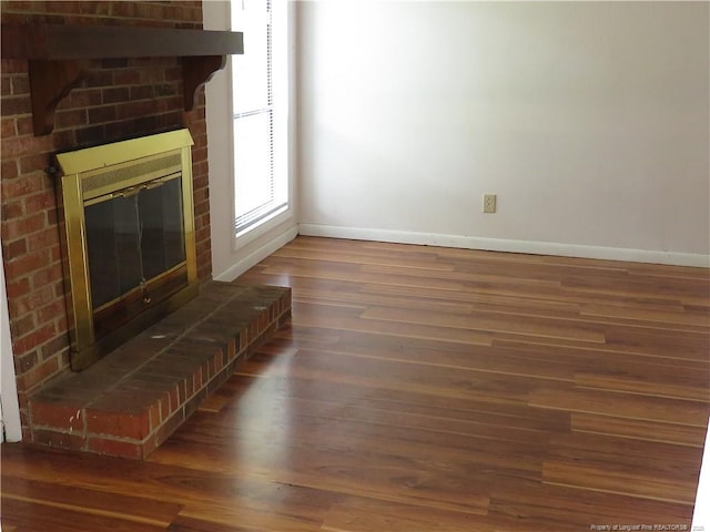 5609 Bowman Ct, Fayetteville, NC 28304 - unfurnished living room with baseboards, a fireplace, and wood finished floors