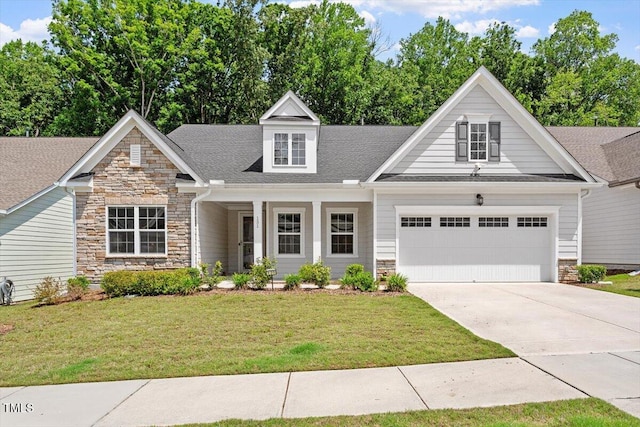 131 English Violet Ln, Raleigh, NC 27610 - view of front of property with stone siding, an attached garage, a front yard, and concrete driveway