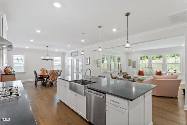131 English Violet Ln, Raleigh, NC 27610 - kitchen featuring stainless steel appliances, a sink, dark countertops, dark wood-style floors, and crown molding