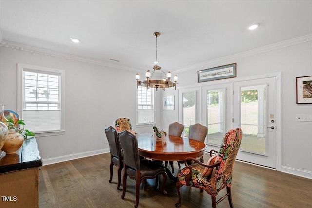 131 English Violet Ln, Raleigh, NC 27610 - dining area featuring dark wood finished floors, a chandelier, plenty of natural light, ornamental molding, and recessed lighting