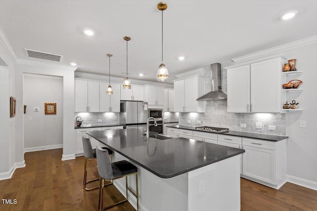 131 English Violet Ln, Raleigh, NC 27610 - kitchen with wall chimney exhaust hood, a sink, appliances with stainless steel finishes, dark countertops, and baseboards