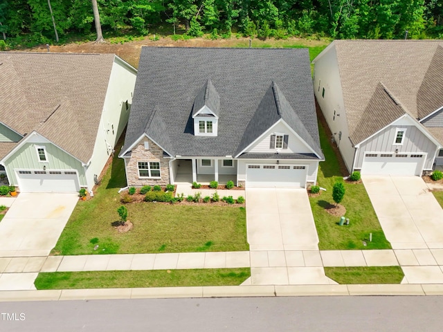 131 English Violet Ln, Raleigh, NC 27610 - craftsman-style house with stone siding, driveway, a garage, and roof with shingles