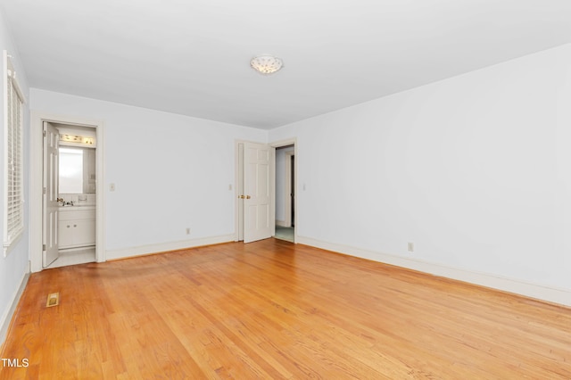 411 W Killiegrey St, Lillington, NC 27546 - empty room featuring light wood-style floors and baseboards