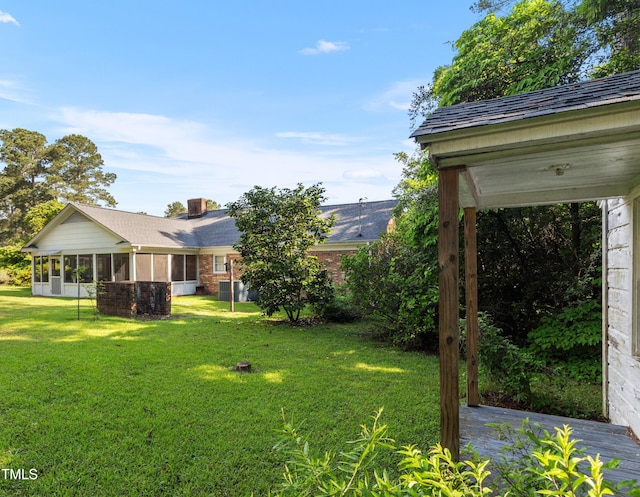 411 W Killiegrey St, Lillington, NC 27546 - view of grassy yard with a sunroom and central air condition unit