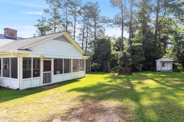411 W Killiegrey St, Lillington, NC 27546 - view of green lawn with a sunroom, a shed, and an outbuilding