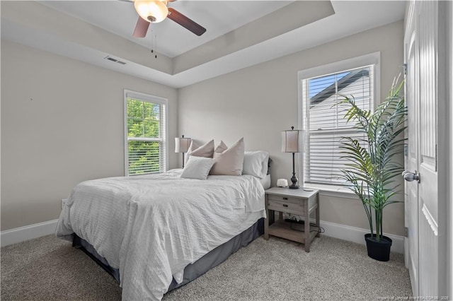 bedroom featuring baseboards, light colored carpet, and ceiling fan