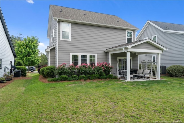 back of house featuring a patio area, a yard, and central AC