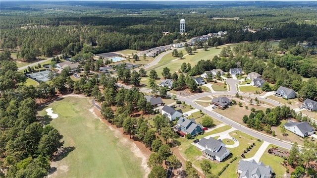 aerial overview of property's location featuring a heavily wooded area, nearby suburban area, and a golf club
