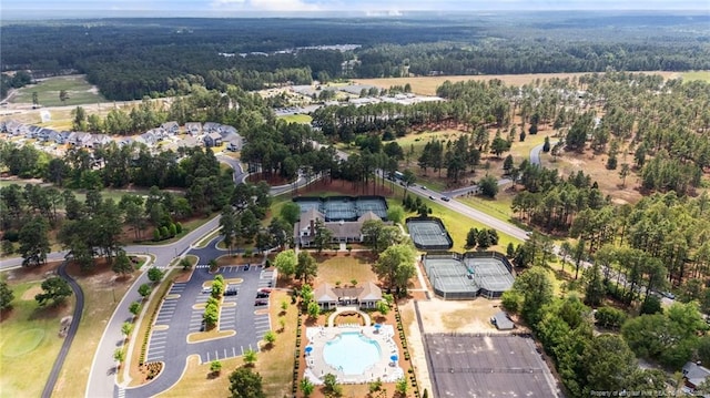 aerial overview of property's location featuring a pool area and a heavily wooded area