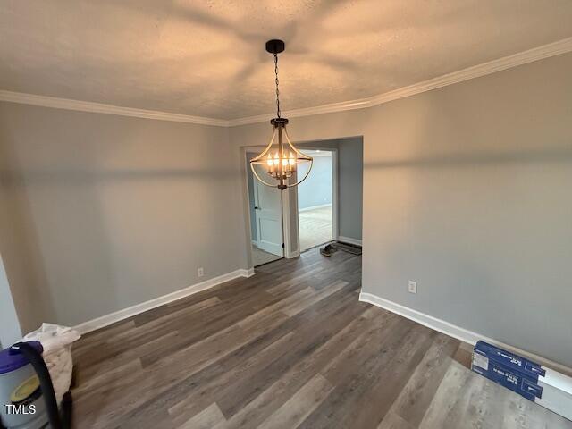 65 Prospect Church Rd, Erwin, NC 28339 - unfurnished dining area featuring a chandelier, baseboards, dark wood finished floors, and crown molding