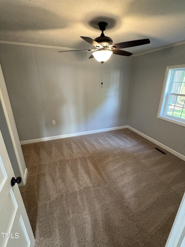 65 Prospect Church Rd, Erwin, NC 28339 - carpeted spare room featuring a textured ceiling, a ceiling fan, ornamental molding, and baseboards