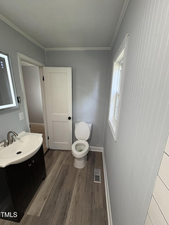 65 Prospect Church Rd, Erwin, NC 28339 - bathroom featuring wood finished floors, vanity, crown molding, and toilet
