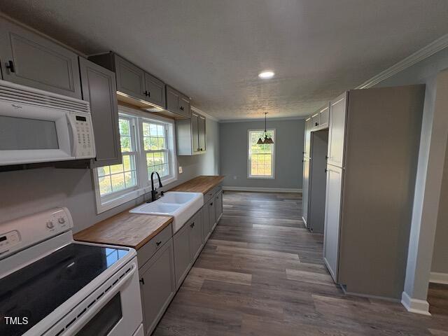 65 Prospect Church Rd, Erwin, NC 28339 - kitchen with white appliances, baseboards, dark wood-style floors, crown molding, and a sink