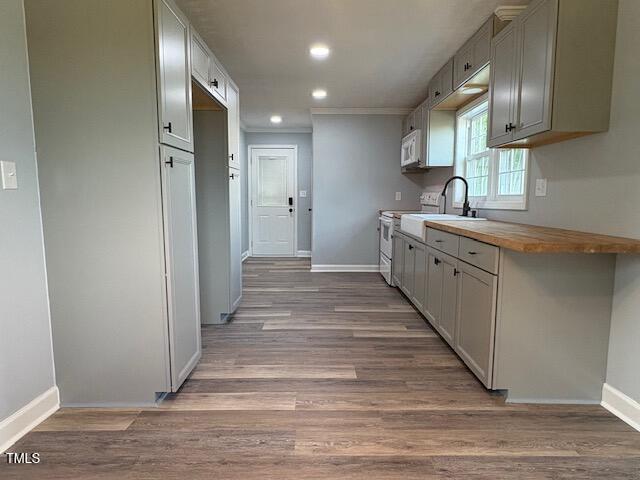 65 Prospect Church Rd, Erwin, NC 28339 - kitchen with white appliances, baseboards, wood finished floors, and recessed lighting