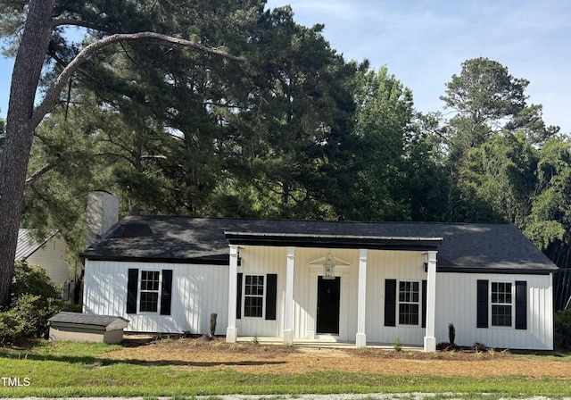 65 Prospect Church Rd, Erwin, NC 28339 - view of front of property with a chimney, a porch, and a front yard