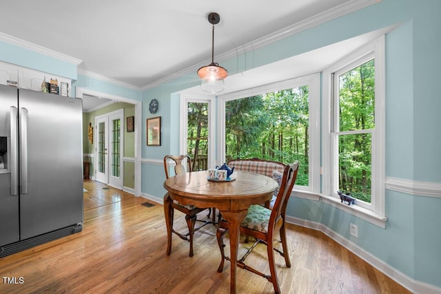 4 Barkridge Ct, Durham, NC 27713 - dining room with baseboards, light wood-style flooring, crown molding, and french doors