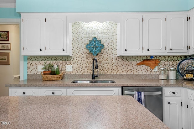 4 Barkridge Ct, Durham, NC 27713 - kitchen with a sink, stainless steel dishwasher, white cabinetry, and decorative backsplash