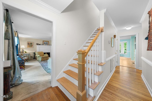 4 Barkridge Ct, Durham, NC 27713 - stairway featuring crown molding, wood finished floors, and a fireplace
