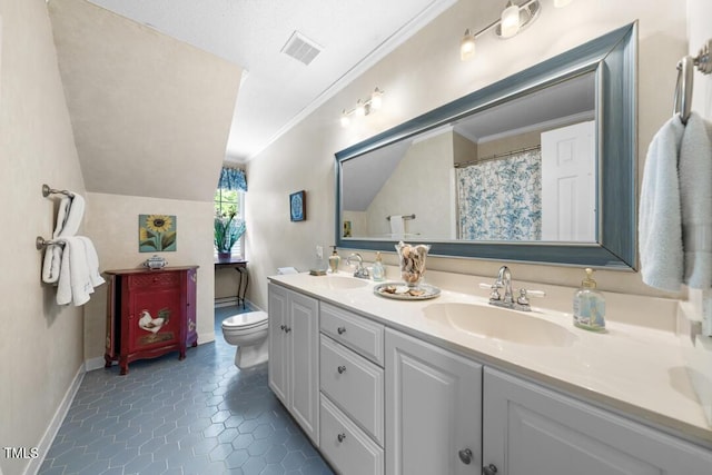 4 Barkridge Ct, Durham, NC 27713 - bathroom with double vanity, toilet, vaulted ceiling, ornamental molding, and tile patterned floors