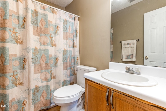 bathroom featuring toilet, vanity, a shower with shower curtain, and a textured ceiling