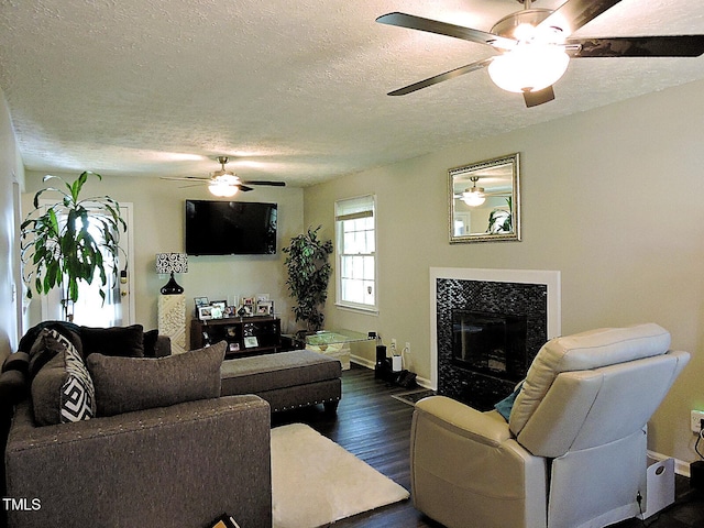 8 Woodsprite Ct, Durham, NC 27703 - living room featuring a textured ceiling, ceiling fan, dark wood finished floors, baseboards, and a fireplace