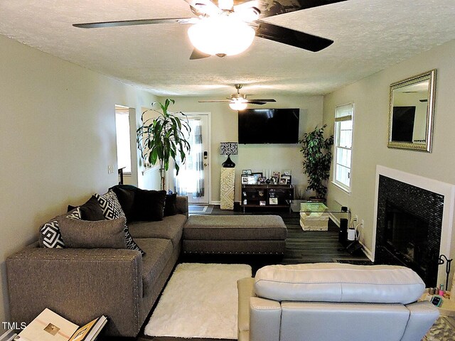 8 Woodsprite Ct, Durham, NC 27703 - living room with ceiling fan, a fireplace, a textured ceiling, and baseboards