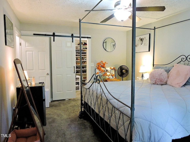 8 Woodsprite Ct, Durham, NC 27703 - bedroom featuring a barn door, carpet, ceiling fan, and a textured ceiling