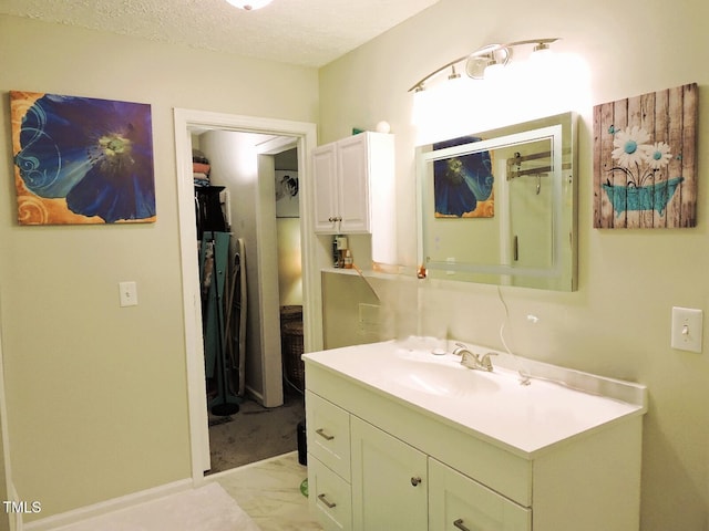 8 Woodsprite Ct, Durham, NC 27703 - bathroom featuring marble finish floors, vanity, and a textured ceiling