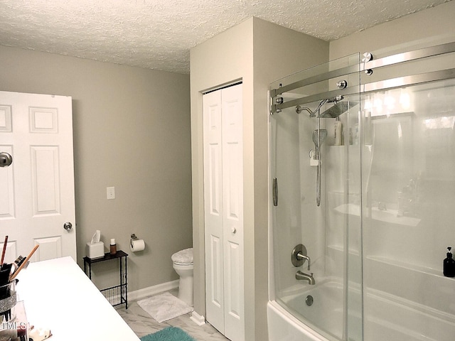 8 Woodsprite Ct, Durham, NC 27703 - full bath with marble finish floors, toilet, bath / shower combo with glass door, a textured ceiling, and a closet