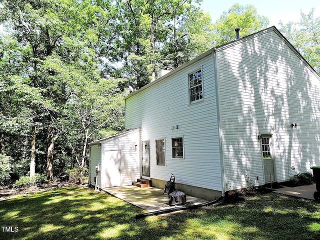 8 Woodsprite Ct, Durham, NC 27703 - back of house featuring a yard, a patio, a chimney, and entry steps