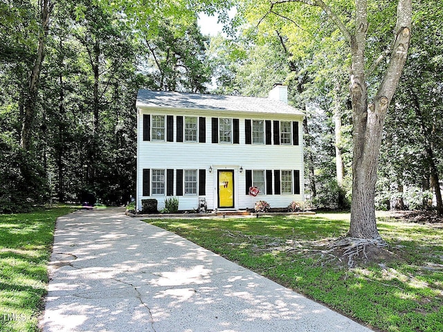 8 Woodsprite Ct, Durham, NC 27703 - colonial-style house featuring a chimney, driveway, and a front yard