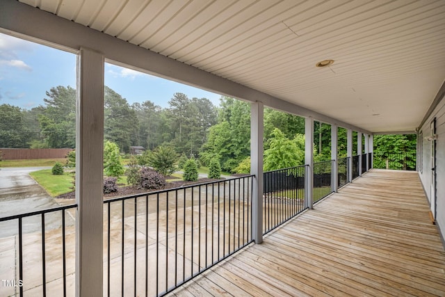 wooden deck featuring view of scattered trees