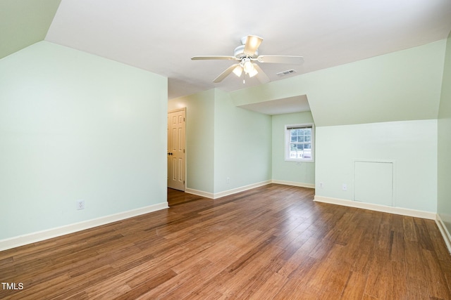 additional living space with a ceiling fan, wood finished floors, baseboards, and vaulted ceiling